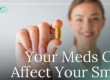 Woman holding up a pill