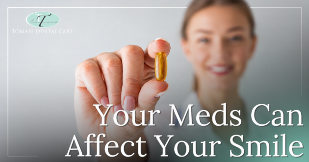 Your Meds Can Affect Your Smile Woman holding up a pill